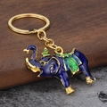 Three-dimensional elephant keychain with blue enamel and gold finish on wood base - Dark Blue
