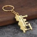Schlüsselanhänger in Gold mit Vintage-Dampflok-Modell aus Metall und poliertem Finish - Gold
