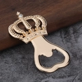 Golden crown bottle opener with diamond accent, elegant European souvenir on wood surface - Gold
