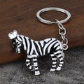 Cute zebra keychain charm featuring black and white enamel stripes and silver metal ring - Silver