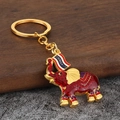 Macro shot of Thai style elephant keychain with red enamel coating and Thailand text - Red