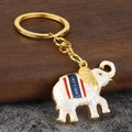 Dettaglio del portachiavi elefante tailandese con smalto bianco e lega dorata - Bianco