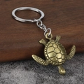 Vintage bronze turtle keychain with detailed shell pattern and sturdy silver key ring - Bronze