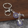 Macro detail of bicycle keychain with polished silver alloy and blue rhinestones - Silver Plated Blue Zirconia