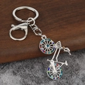 Macro detail of silver bike keychain featuring colorful rhinestones and secure lobster clasp - Silver Multicolor