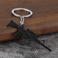Detailed PUBG rifle keychain model with precise scope and magazine details on wood background - Black