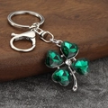 Detailed close-up of a green crystal four-leaf clover keychain with silver lobster clasp - Silver Plated Green