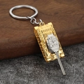Detailed macro view of a T34 tank keychain model with silver and gold metal finishes - Gold