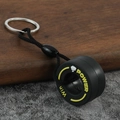 Creative PVC tire keychain with yellow Power text, black woven rope and metal ring - Fist Yellow
