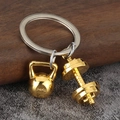 Fitness themed metal keychain with gold-tone kettlebell and dumbbell on a silver ring - Gold