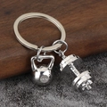 Close-up of polished silver fitness keychain featuring 24KG kettlebell and dumbbell charms - Silver