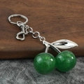 Detail of glitter green resin cherry keychain with silver leaves and lobster clasp - Silver Green