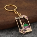 Golden Madina mosque keychain with detailed green dome and floral relief for handbags - Purple