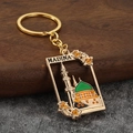 Gold Medina Prophet's Mosque keychain with green dome and MADINA text on wood base - Yellow