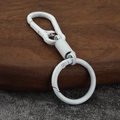 Matte white zinc alloy keychain with spring D-ring carabiner on dark wooden tray - White