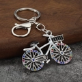 Sparkling rhinestone bicycle keychain with colorful stones on silver metal bike charm - Silver & White