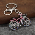 Detail of pink crystal bicycle keychain with sparkling rhinestones on silver alloy wheels - Silver + Pink