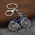 Macro shot of bicycle keychain with colorful rhinestones and blue enamel finish on alloy - Silver & Blue