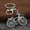 Creative bicycle keychain with rhinestones and lobster clasp on a modern stone surface - Silver Base White Frame