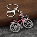 Detail of pink alloy bicycle keychain featuring sparkling rhinestones and sturdy lobster clasp - Silver Base Pink Frame