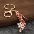 Elegante portachiavi a tacco alto dorato con strass rossi e ciondolo a fiore di cristallo - Rosso