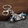 Detailed rhinestone motorcycle keychain in silver and blue metal on a stone surface - Silver & Blue