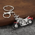 Macro detail of silver motorcycle keychain with sparkling rhinestones and lobster clasp - Silver White + Red