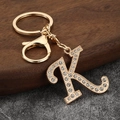 Detailed close-up of gold alloy letter K keychain with sparkling inlaid rhinestones - Letter K