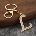 Detailed view of golden letter L keychain with sparkling rhinestones and lobster clasp - Letter L