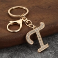 Sparkling gold letter P keychain with rhinestones and lobster clasp on dark background - Letter T