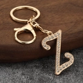 Close-up of golden letter Z keychain with sparkling rhinestones and lobster clasp - Letter Z