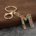 Colorful rhinestone letter M keychain with gold plating for handbags and backpacks - Letter M
