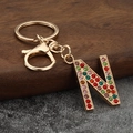 Detailed close-up of letter N keychain featuring vibrant multicolored rhinestones and gold metal - Letter N