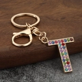 Macro view of gold letter T keychain with colorful rhinestones and lobster clasp - Letter T