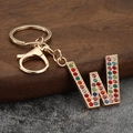 Macro detail of alphabet letter W keychain with colorful rhinestones and gold lobster clasp - Letter W