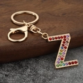 Macro detail of golden letter Z keychain featuring colorful inlaid rhinestones and clasp - Letter Z