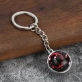 Detailed view of silver Scorpio zodiac keychain with glowing red nebula glass pendant - Scorpio
