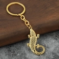 Creative golden crocodile keychain accessory with detailed scales on wood background - Gold