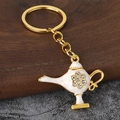 Detail of golden Aladdin lamp keychain with white enamel and rhinestone floral pattern - Gold+White