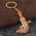 Close-up of golden Jambiya dagger keychain with pink enamel and sparkling rhinestones - Pink
