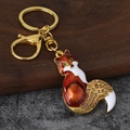 Portachiavi a volpe in smalto con strass arancioni e chiusura a moschettone dorata - Oro Antico Marrone