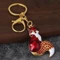 Dettaglio portachiavi a volpe con smalto rosso e coda decorata con cristalli su metallo oro - Oro Antico Rosso