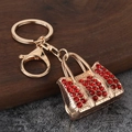 Detail of red rhinestone handbag keychain with gold alloy clasp and crystal embellishment - Gold Red Zirconia