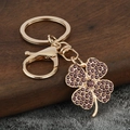 Porte-clés trèfle doré avec strass violets étincelants pour accessoires de sacs à main - Zircone Violette