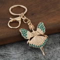 Macro shot of green rhinestone fairy keychain with lobster clasp and gold-plated finish - Dark Green Rhinestone