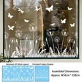 Detailansicht weißer Löwenzahn Fensteraufkleber mit Schmetterlingen auf einer Glasoberfläche - 1 Blatt (30x60cm)
