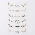 Golden Christmas freckle tattoos with snowflake and reindeer patterns for holiday makeup - Gold G