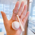 Mini baseball and wooden bat keychain with silver ring shown in hand for scale - 3.5CM White Ball 7.5CM Bat