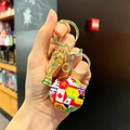 Macro view of gold trophy and multicolor soccer ball keychain with world flag patterns - National Flag Soccer Ball + Gold Trophy + Lobster Clasp