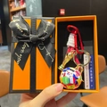 Macro shot of World Cup trophy keychain in orange gift box with woven strap and soccer ball - Soccer Ball + Trophy + Sign + Multi Braid + Orange Gift Box